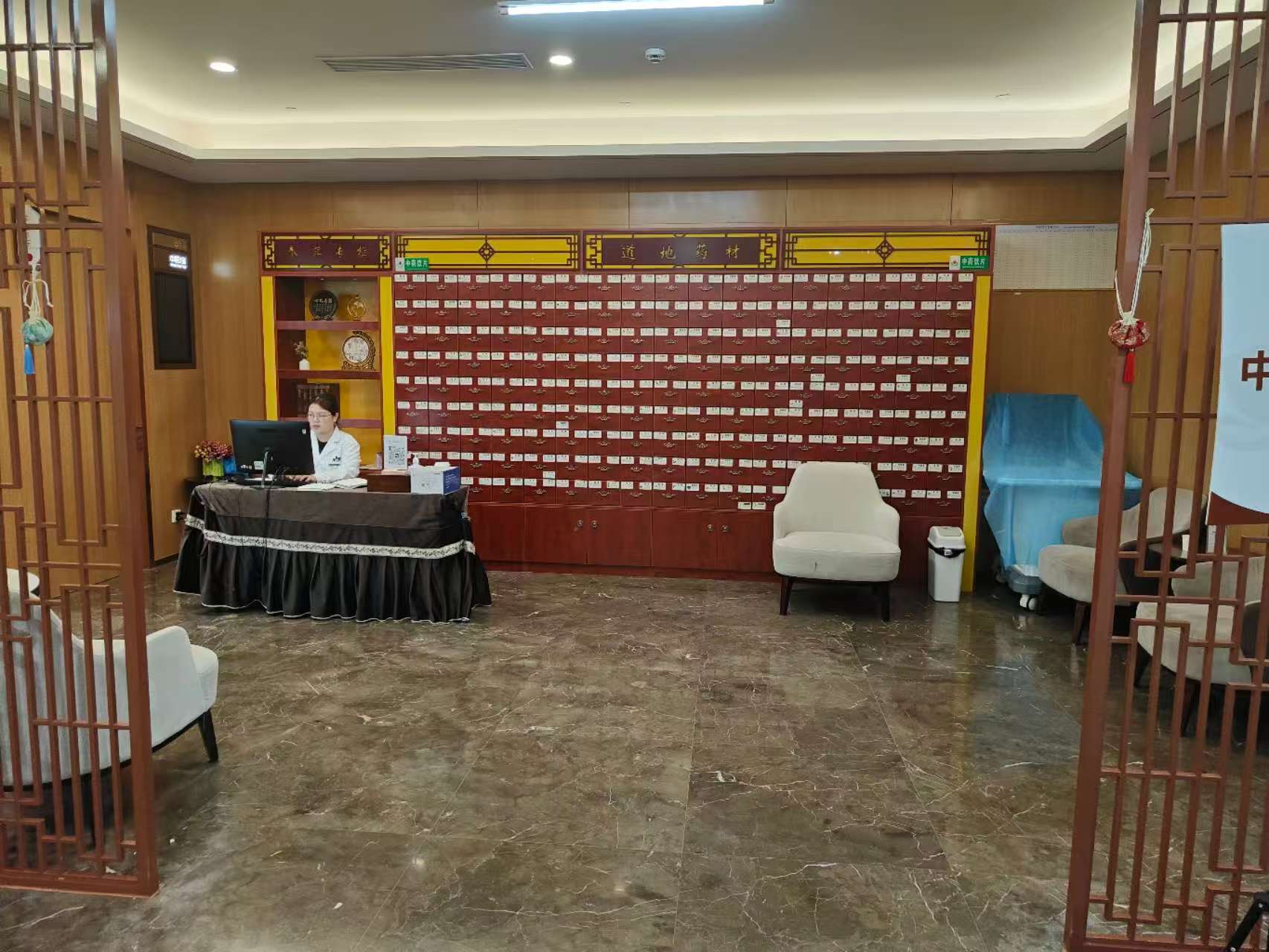 Client-supplied photograph of a traditional Chinese medicine area with a herbal medicine cabinet