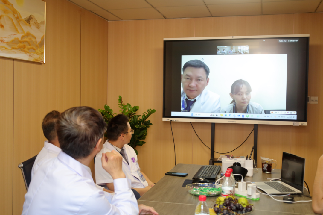 Medical team coordinating a remote specialist consultation in a meeting room