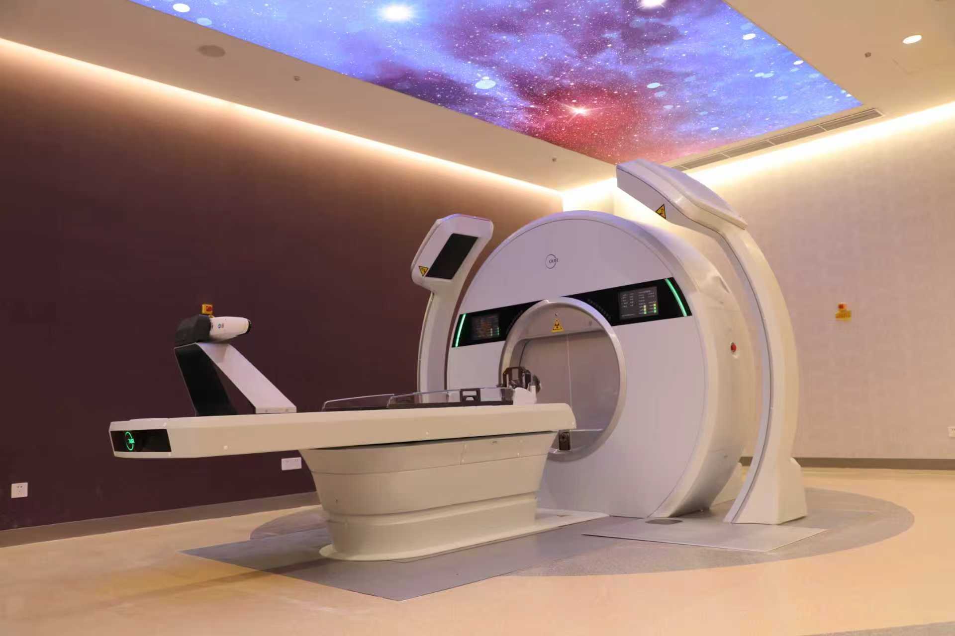 Medical treatment equipment and a patient table beneath an illuminated star-pattern ceiling